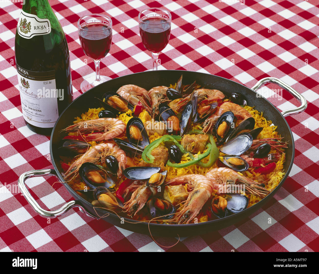 Spanish paella and red wine Stock Photo Alamy