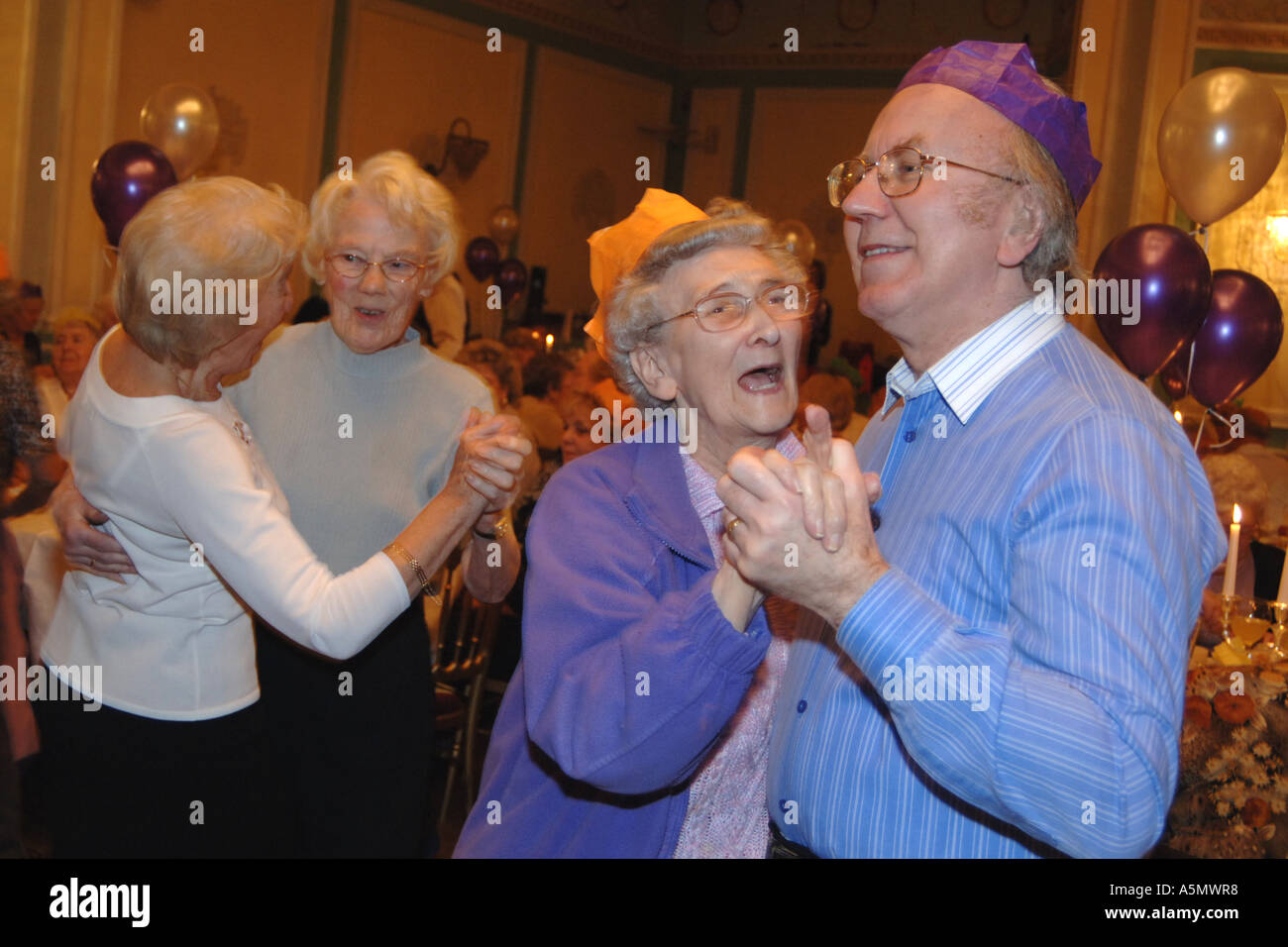 Elderly couples enjoy a dance at a Christmas party West Yorkshire UK Stock Photo
