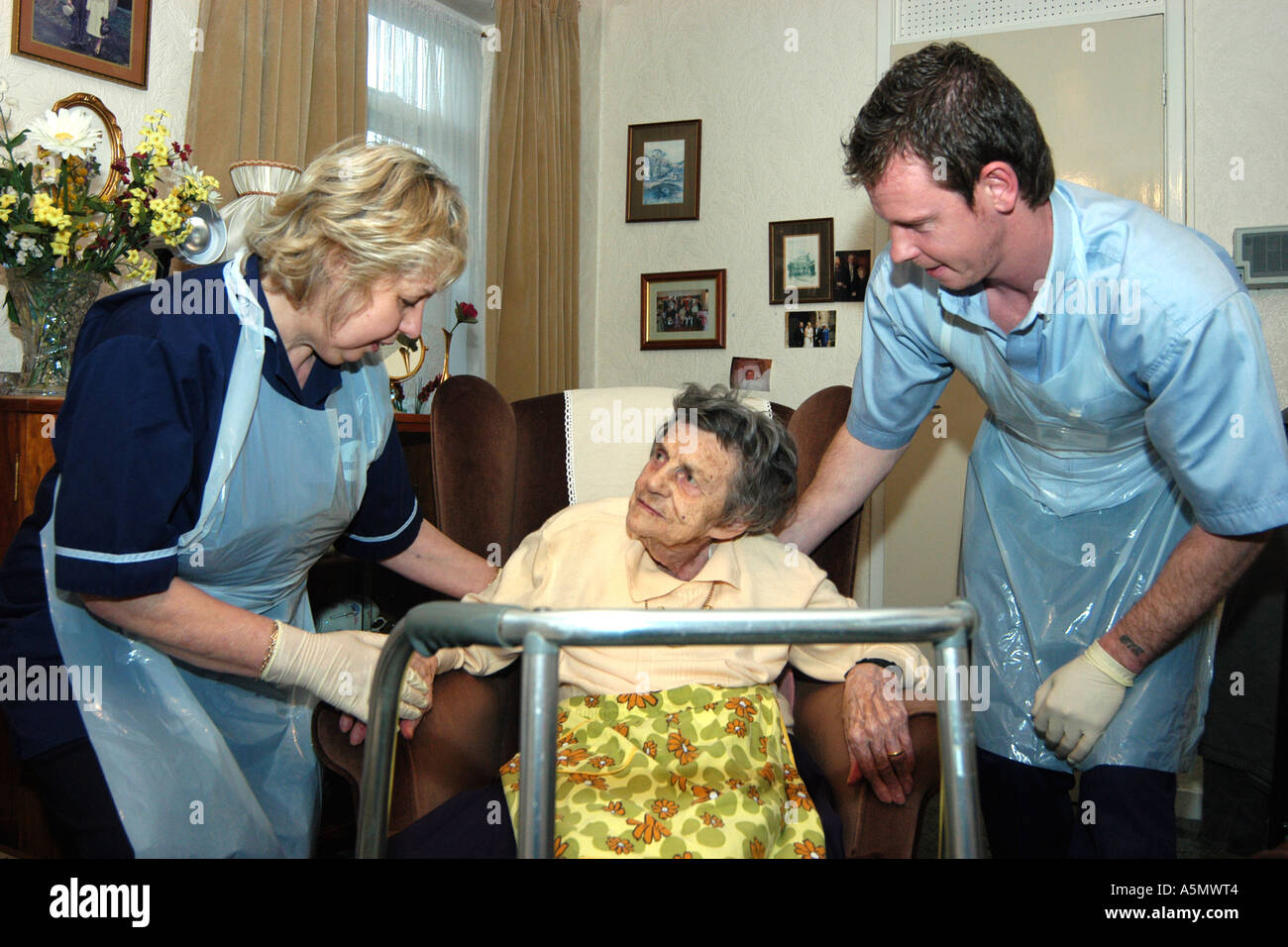 An Elderly woman is helped in her home by Council Home Help Workers West Yorkshire Stock Photo