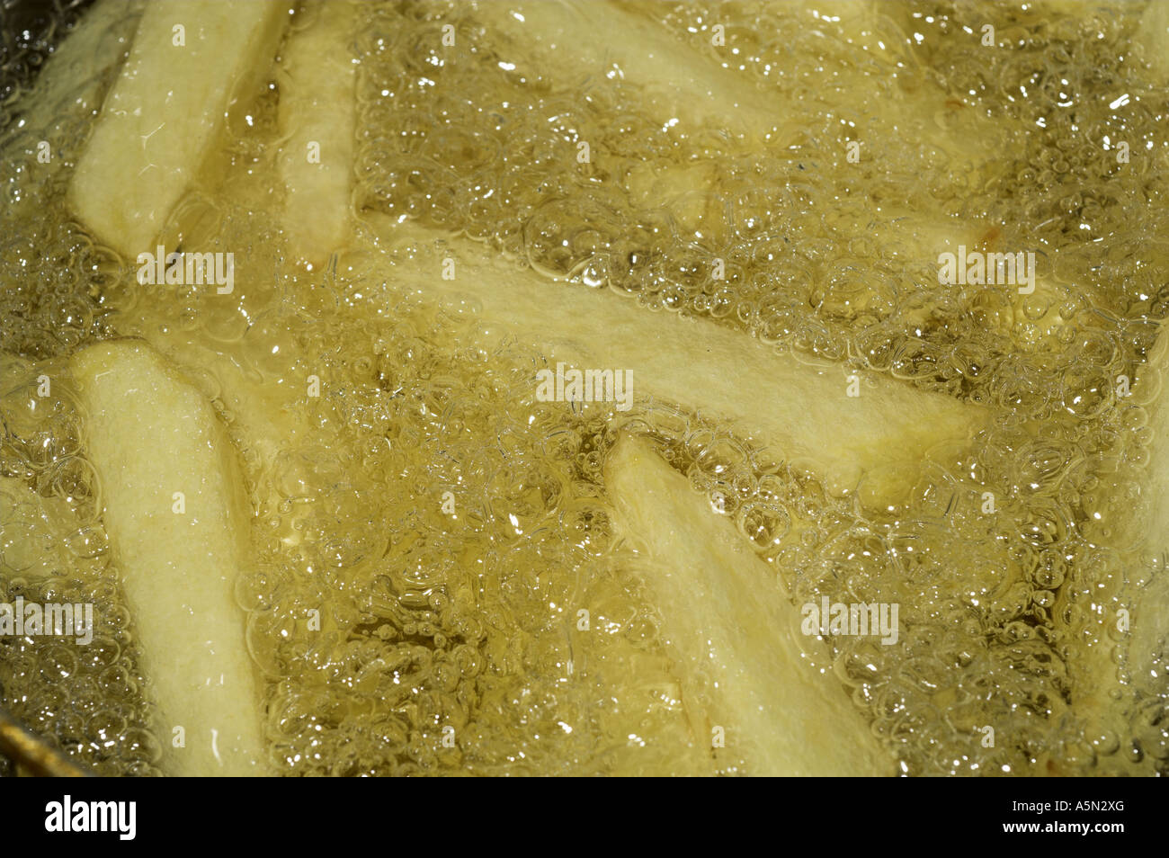 Home made chips frying in sunflower oil Stock Photo Alamy
