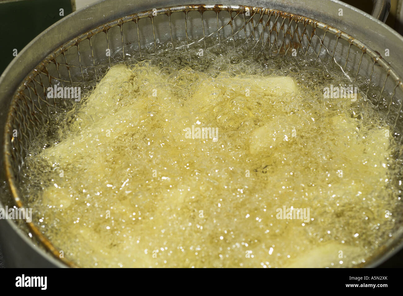Home made chips frying in sunflower oil Stock Photo Alamy