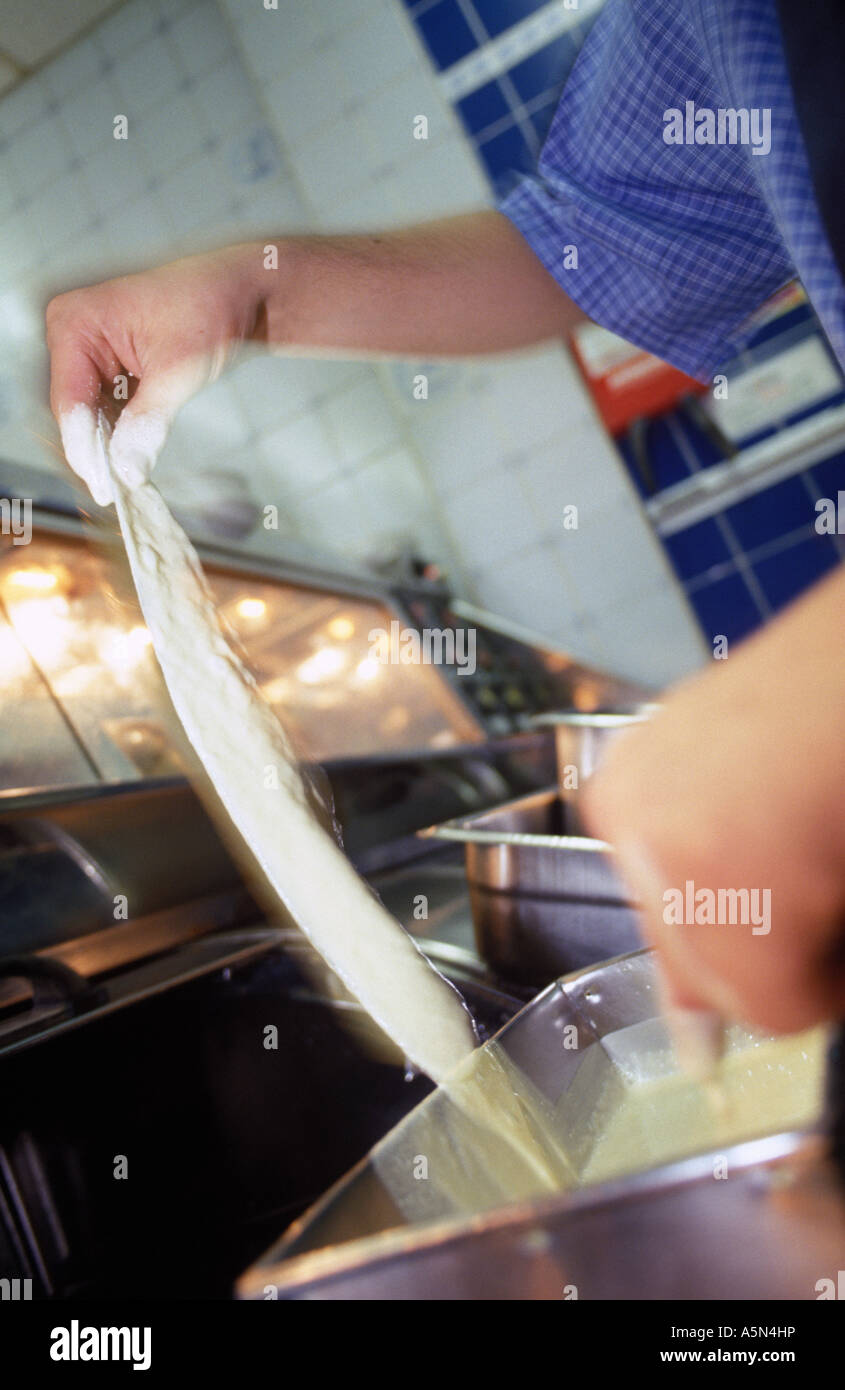 battering a fish in a fish shop Stock Photo