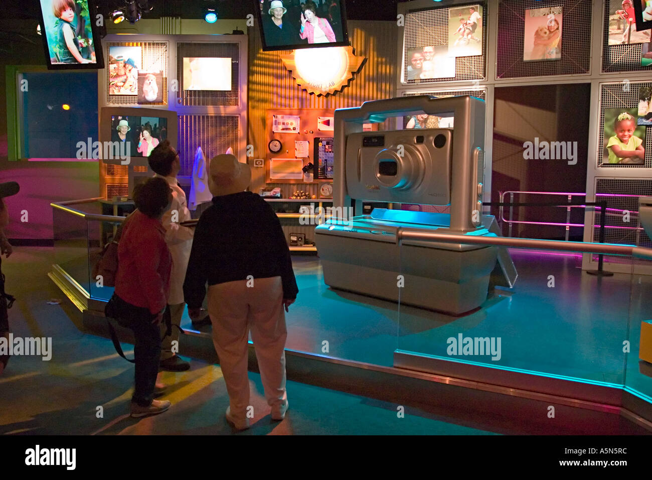 Visitors viewing photos by giant Kodak camera in Imagination exhibit Epcot Walt Disney World Orlando Florida Stock Photo