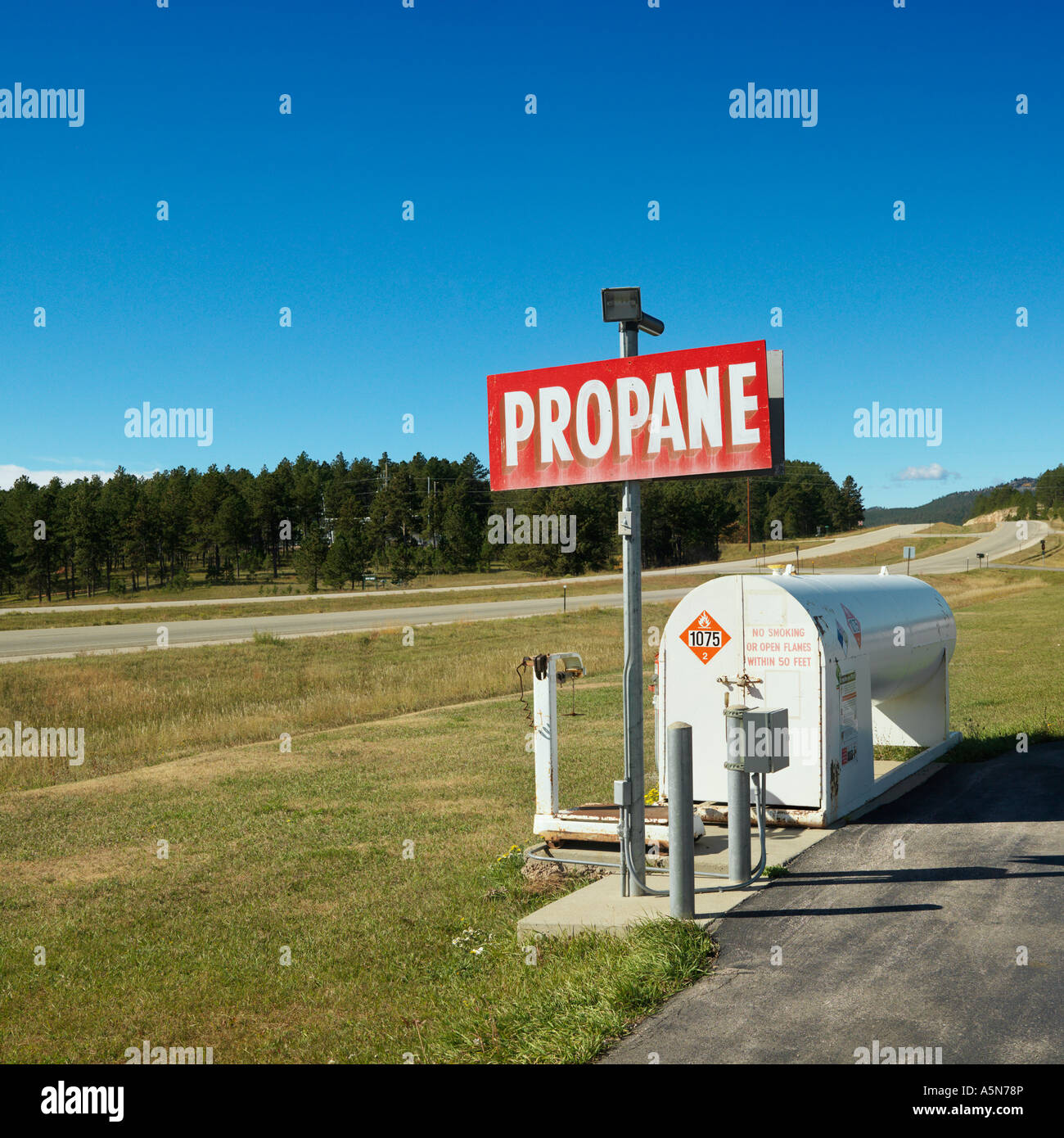 Propane tank with sign on side of rural road Stock Photo Alamy