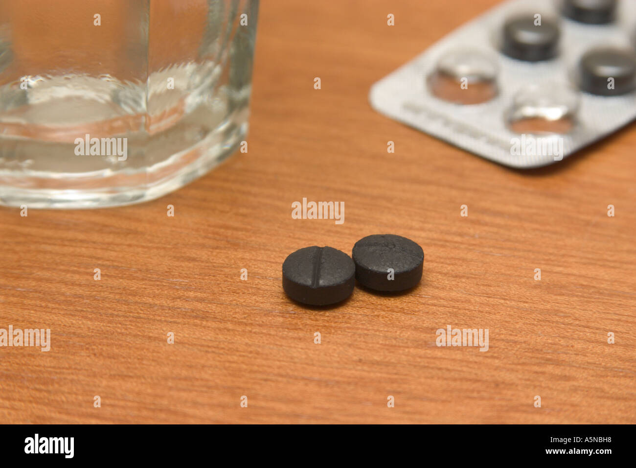 glass of water and activated charcoal pills Stock Photo Alamy