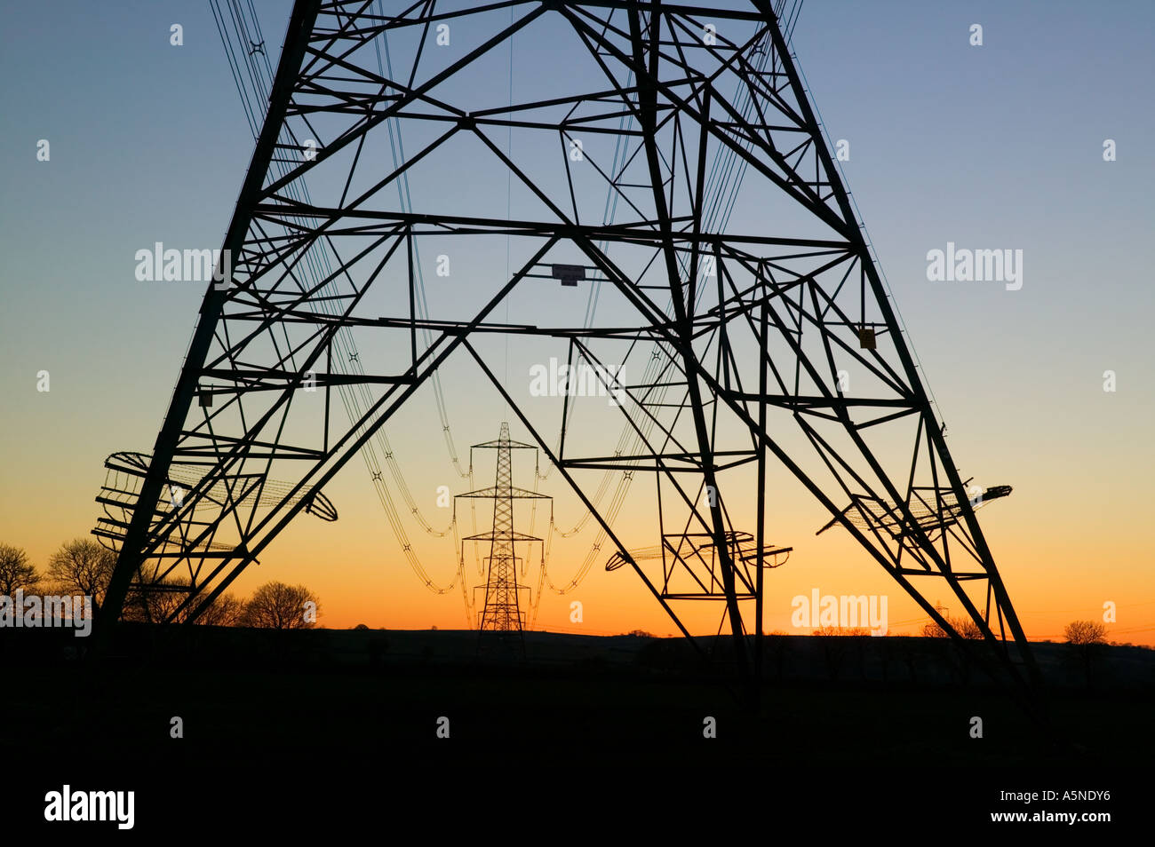 An electricity pylon of the National Grid in Wales at sunset Stock Photo