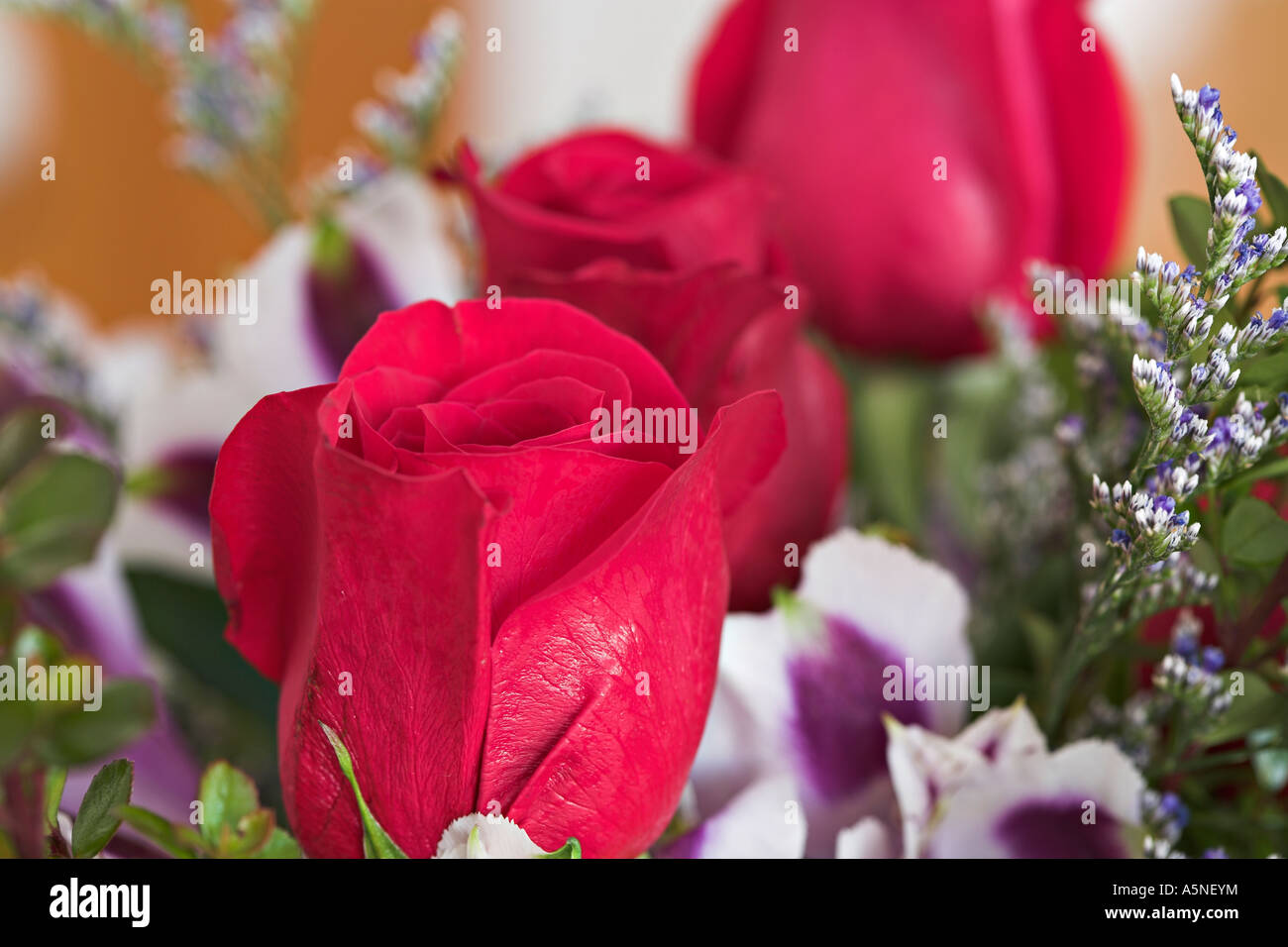 Bouquet with Roses Three rose buds surrounded by other flowers in a
