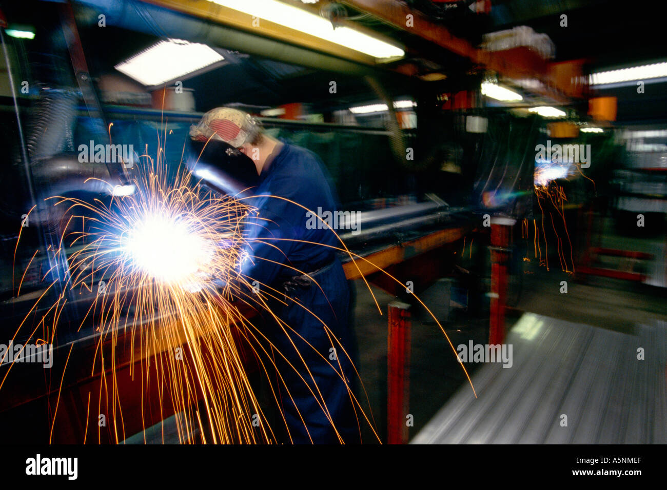 A welder at work in a factory. Stock Photo