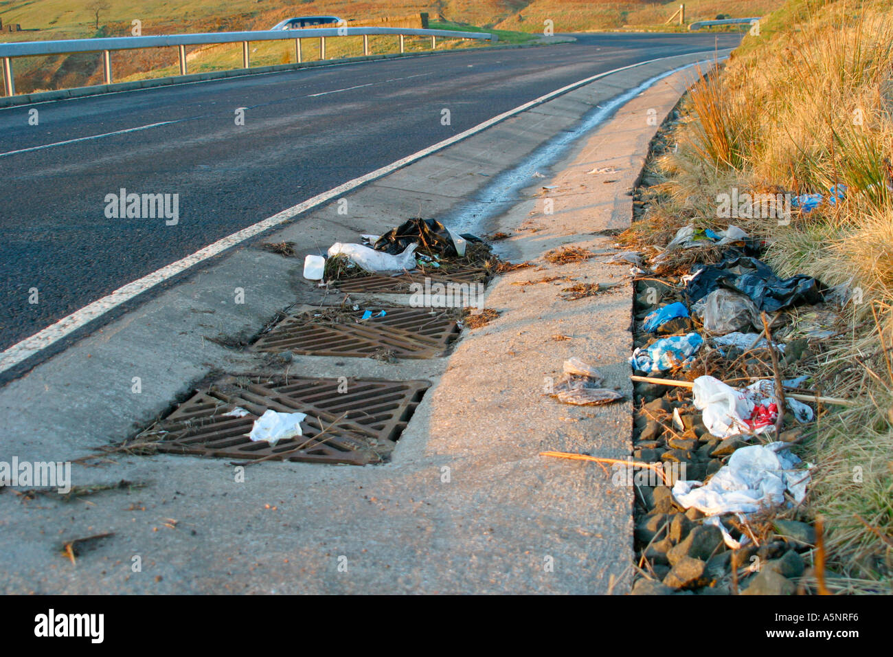 Rubbish lying in the gutter at side of road Stock Photo Alamy