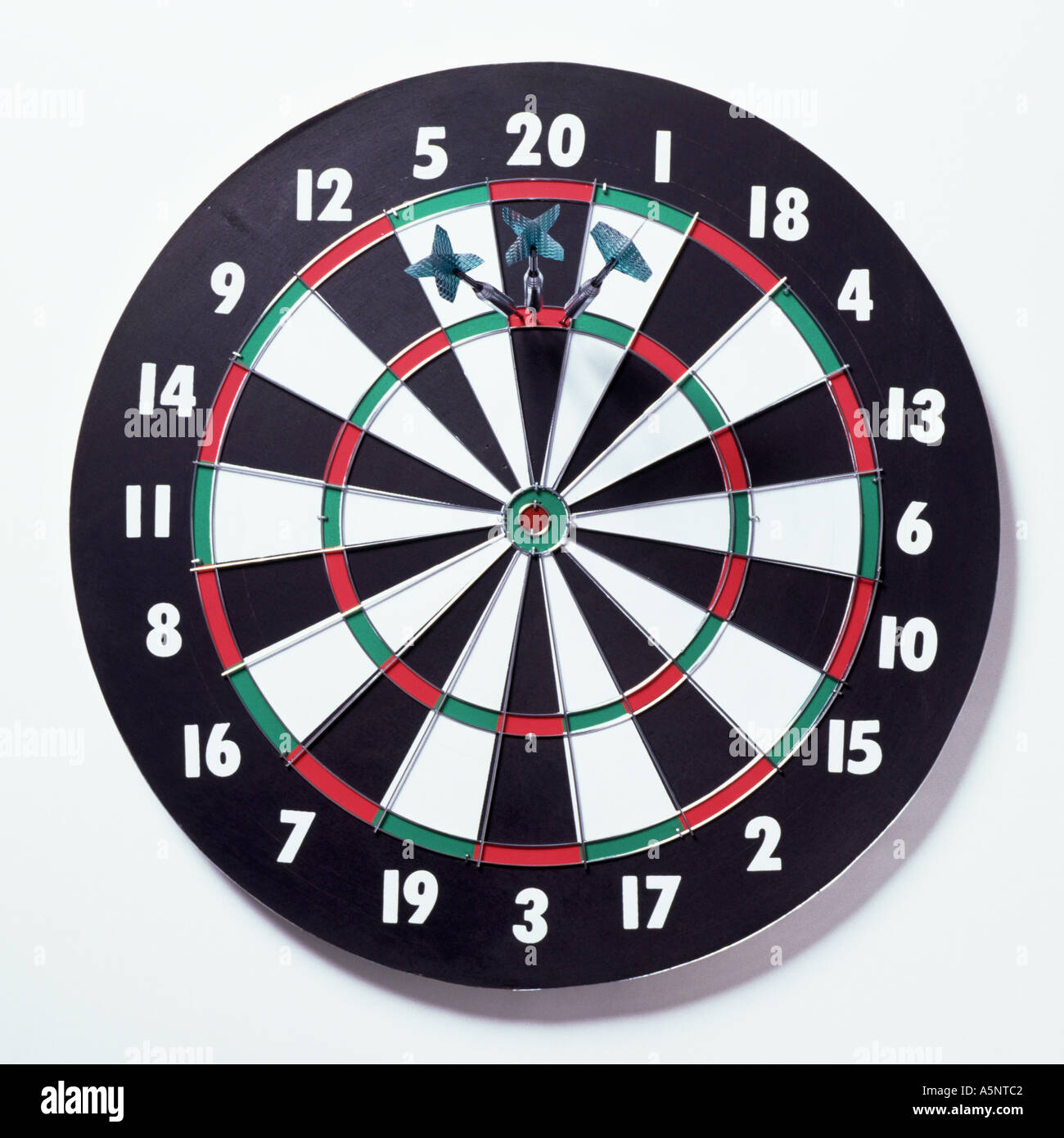 Three darts on a dartboard scoring 180 Stock Photo