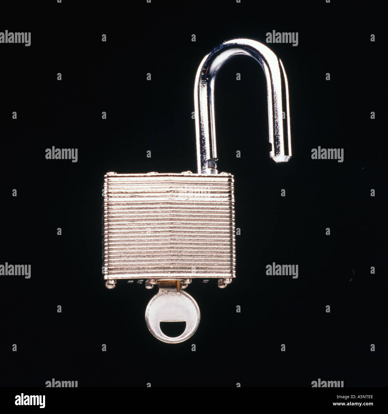 An unlocked padlock with key Stock Photo