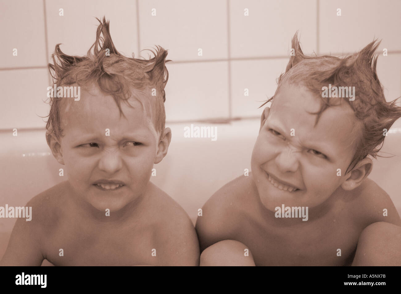 Two little boys 5 and 7 year old in the bath tub Stock Photo Alamy