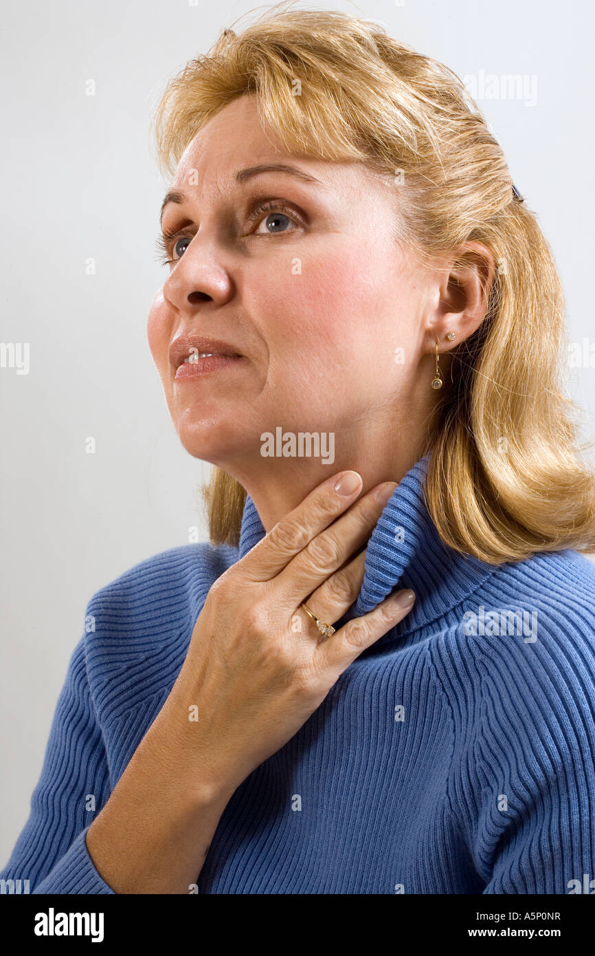 Middle aged woman with sore throat. Stock Photo