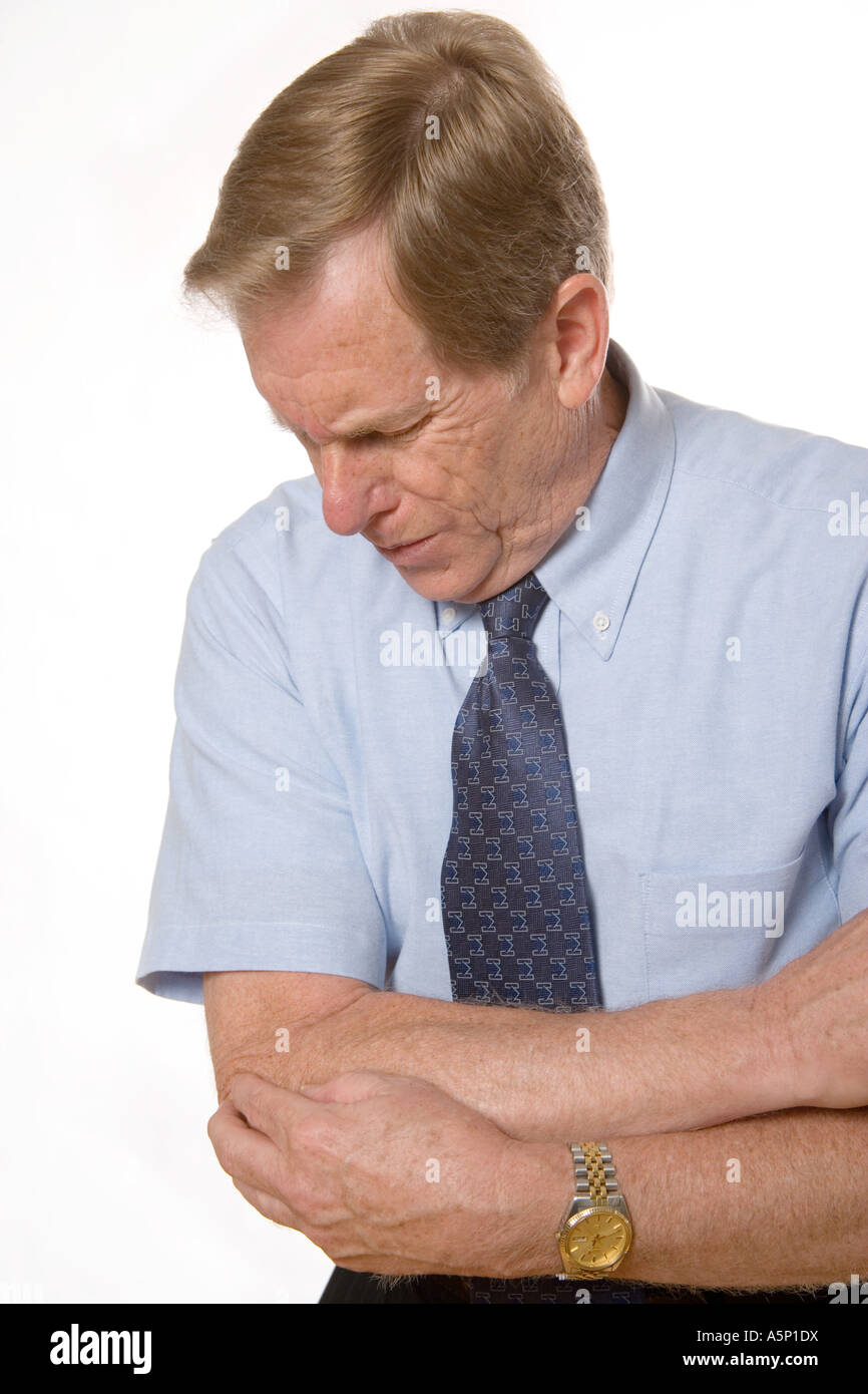 Man experiences pain in his elbow. Stock Photo