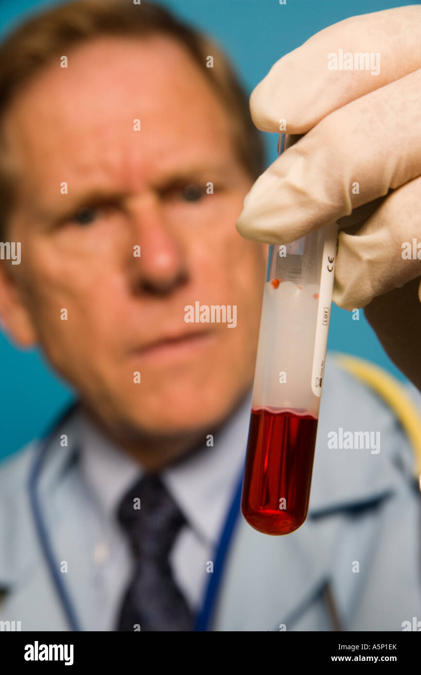 Physician inspects a blood sample in a test tube vial Stock Photo Alamy