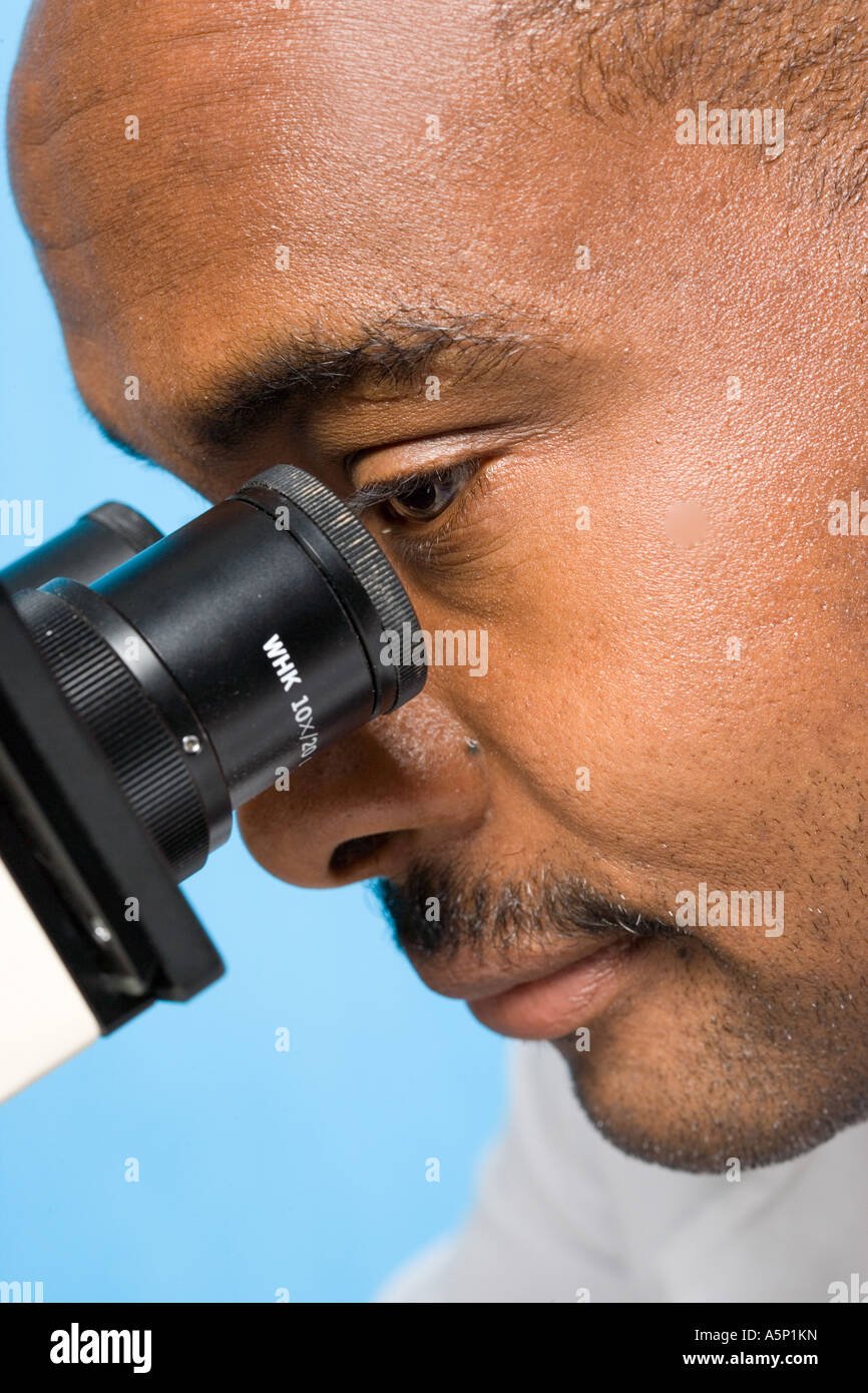 Male looking into microscope Stock Photo Alamy