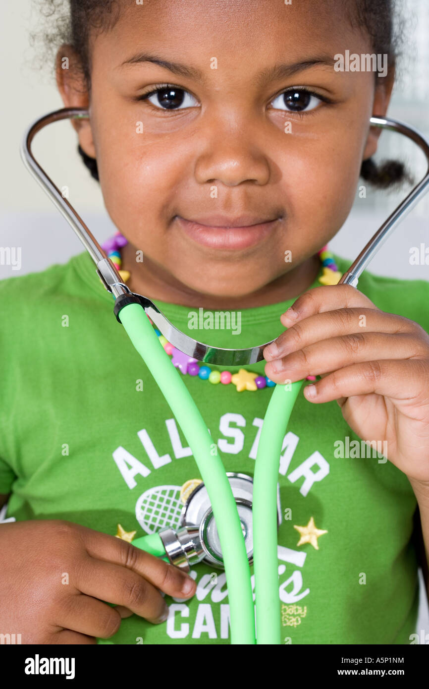 Young girl plays with stethoscope. Playing doctor Stock Photo Alamy
