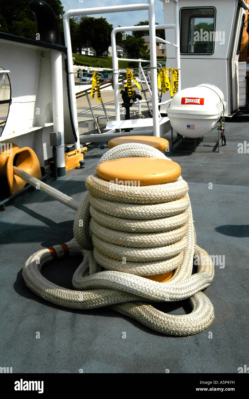 Coiled rope tied around a ships moaring capstans Stock Photo - Alamy