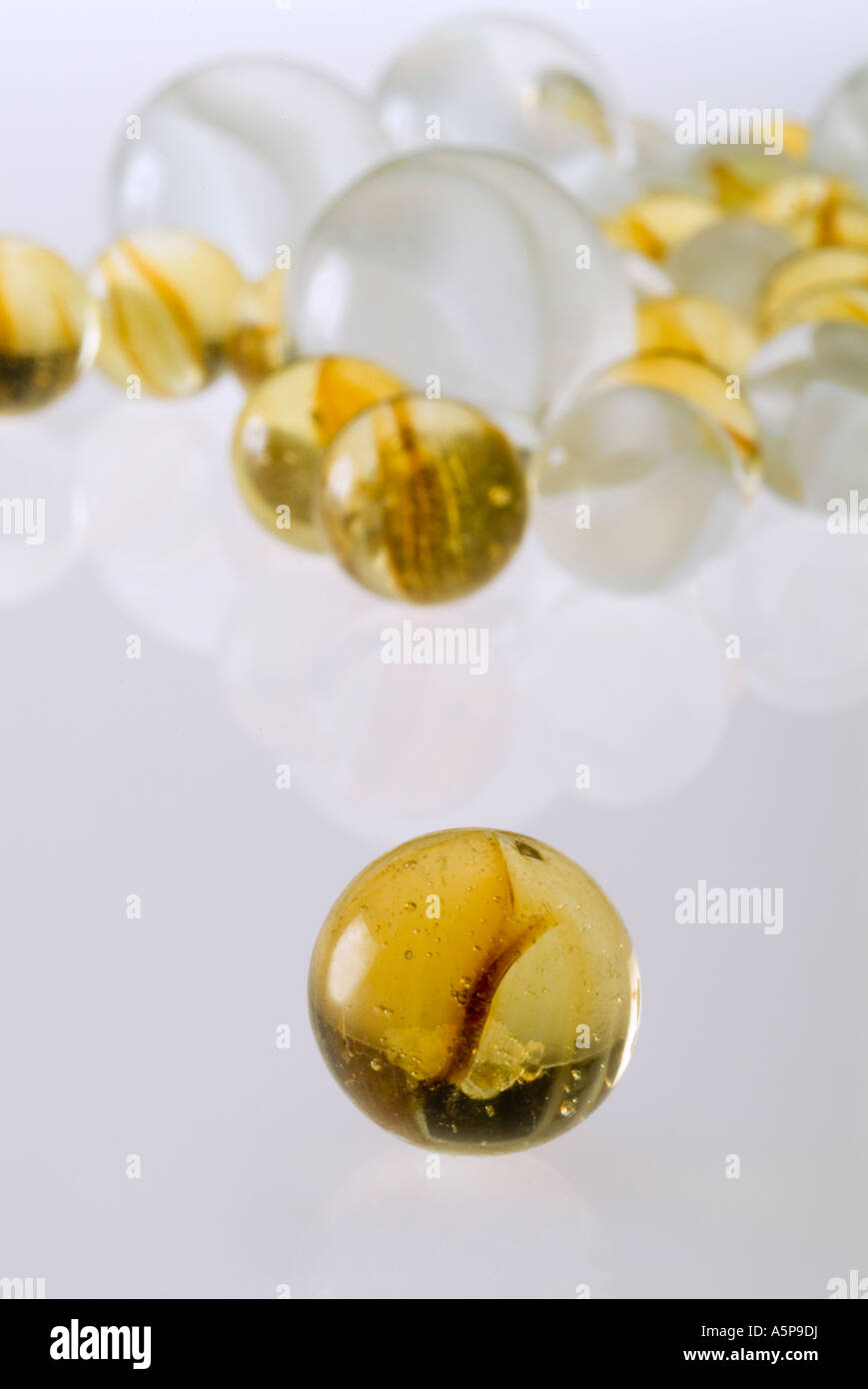 Collection of glass marbles with large marble separate from the rest