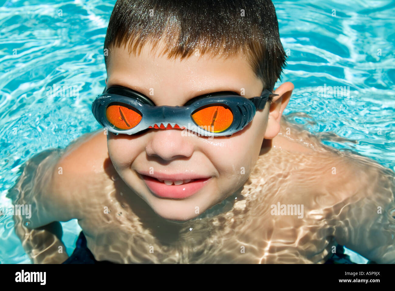Boy wearing goggles in swimming pool Stock Photo Alamy