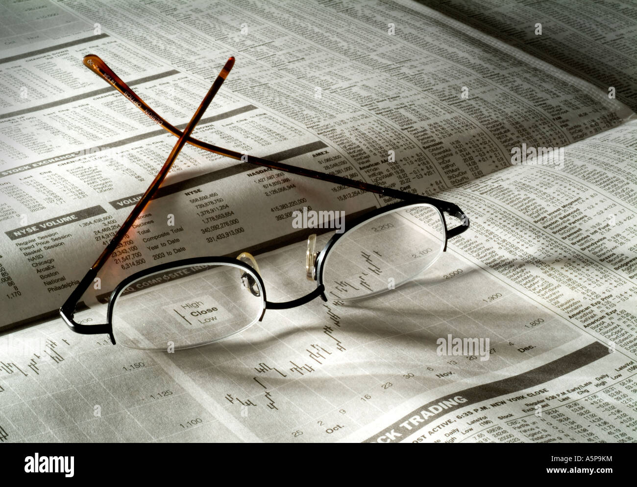Eyeglasses  on financial pages. Stock Photo