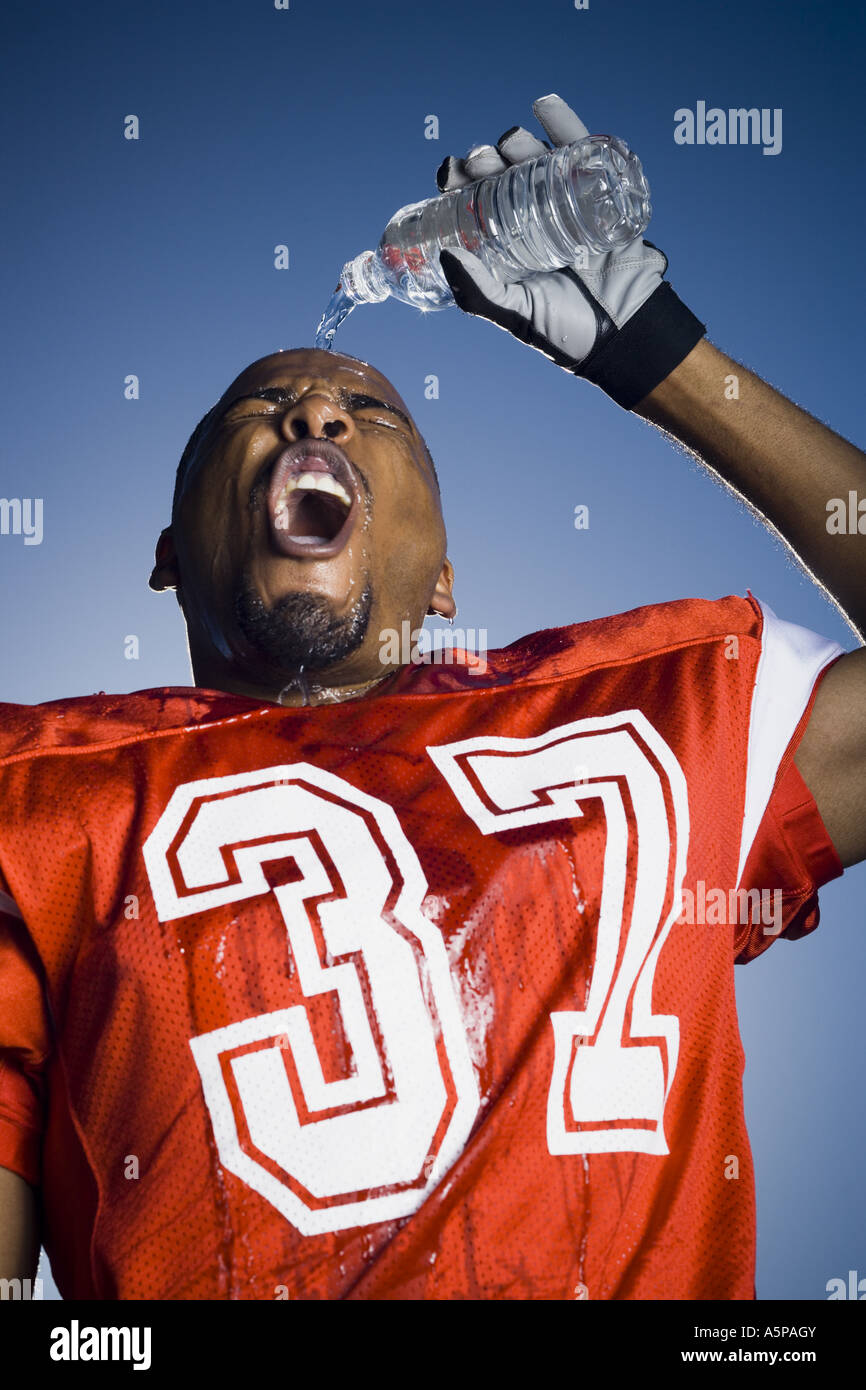 Football player cooling off with water Stock Photo - Alamy