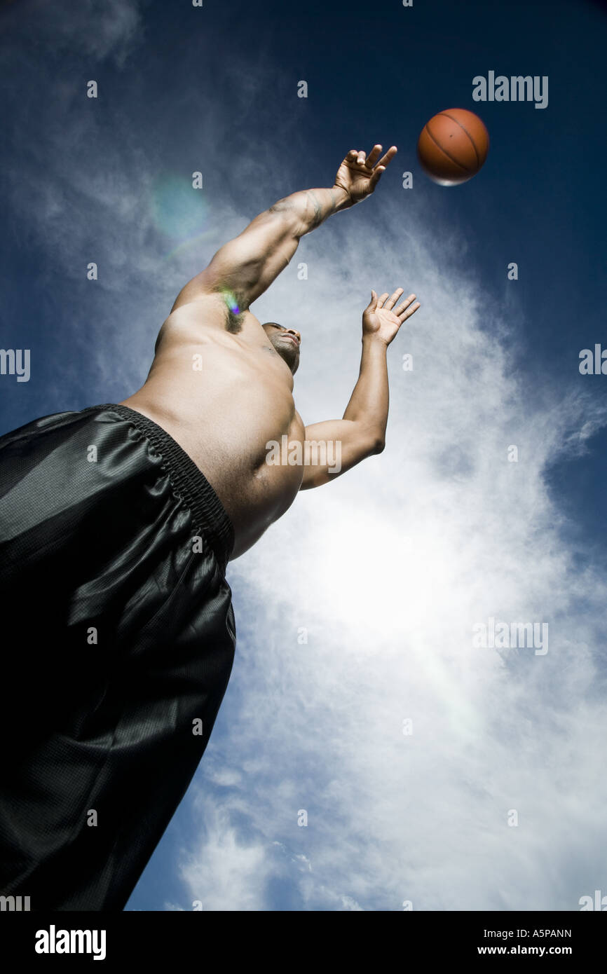Basketball player shooting ball Stock Photo - Alamy