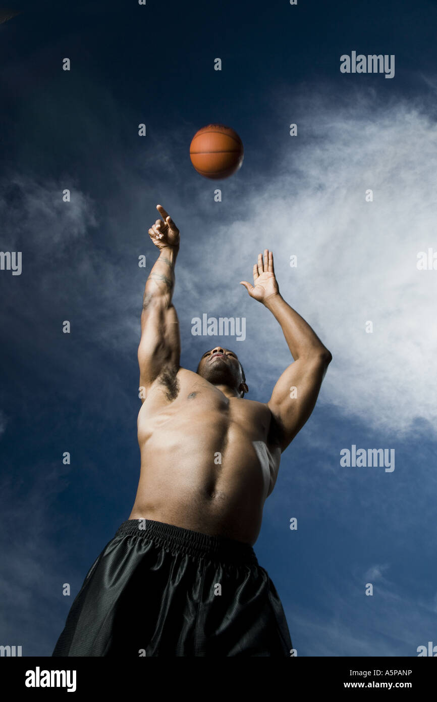 Basketball player shooting ball Stock Photo - Alamy