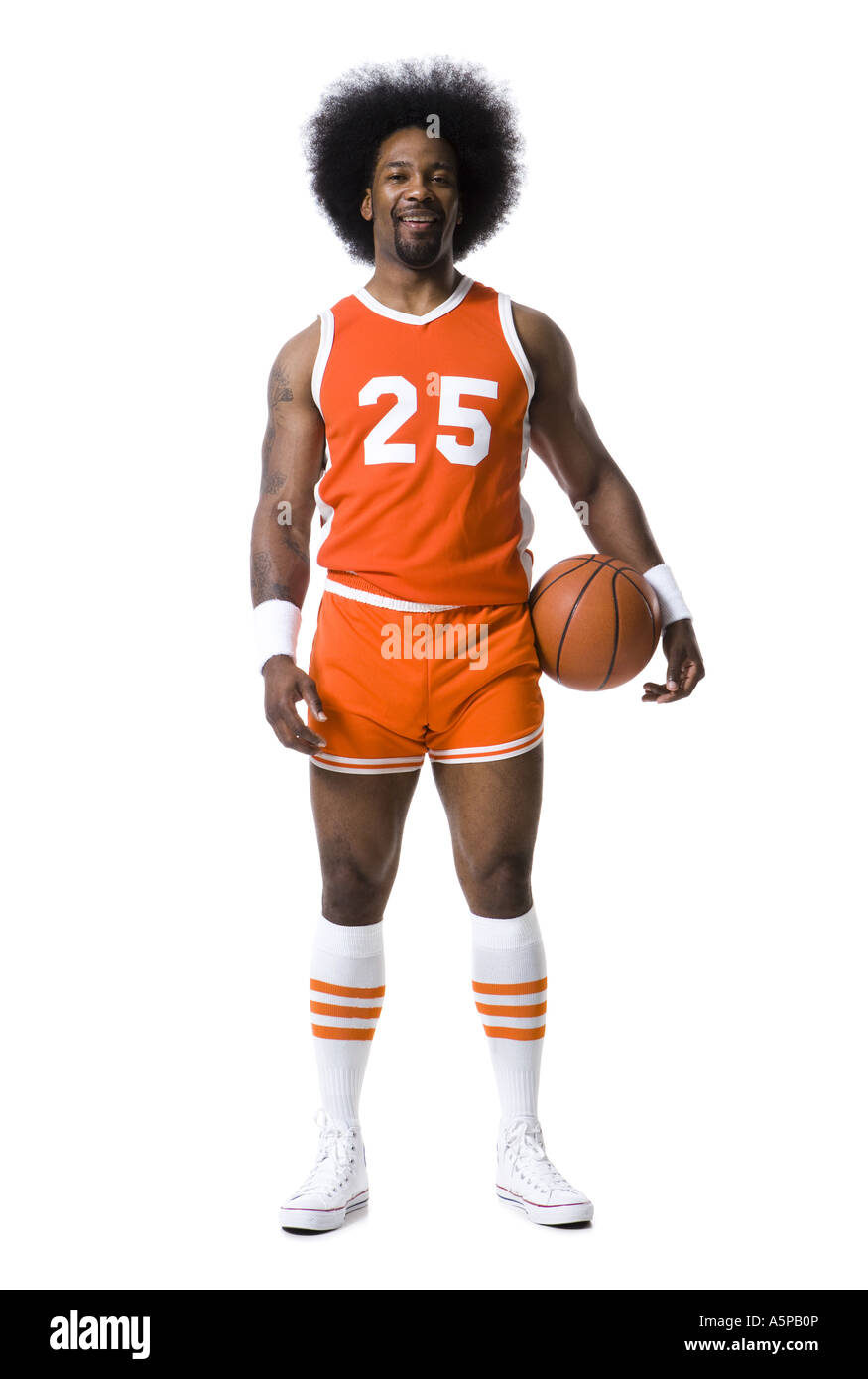 Basketball player with an afro in orange uniform Stock Photo - Alamy