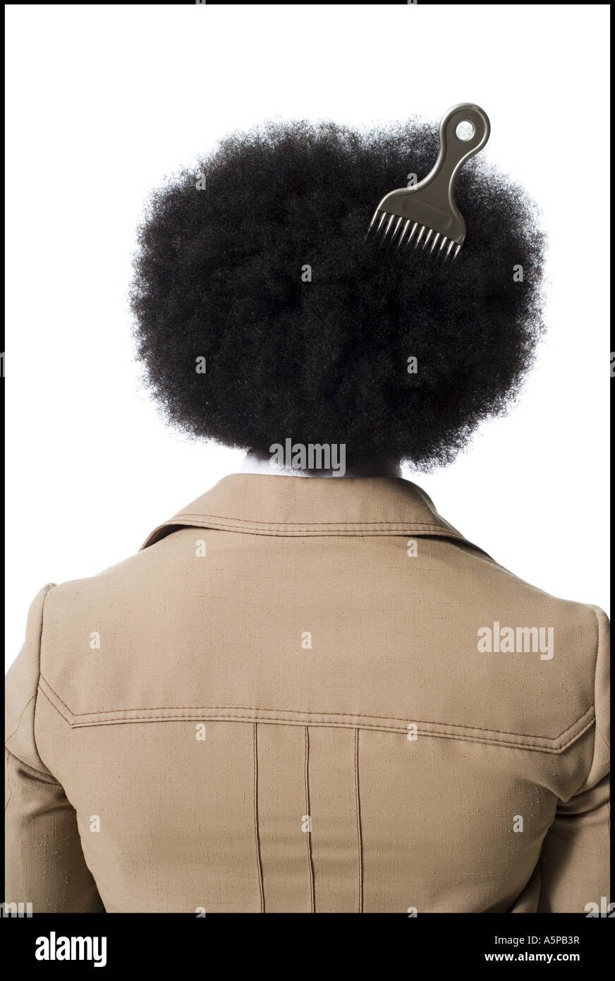Man with an afro in beige suit with hair pick in hair Stock Photo - Alamy