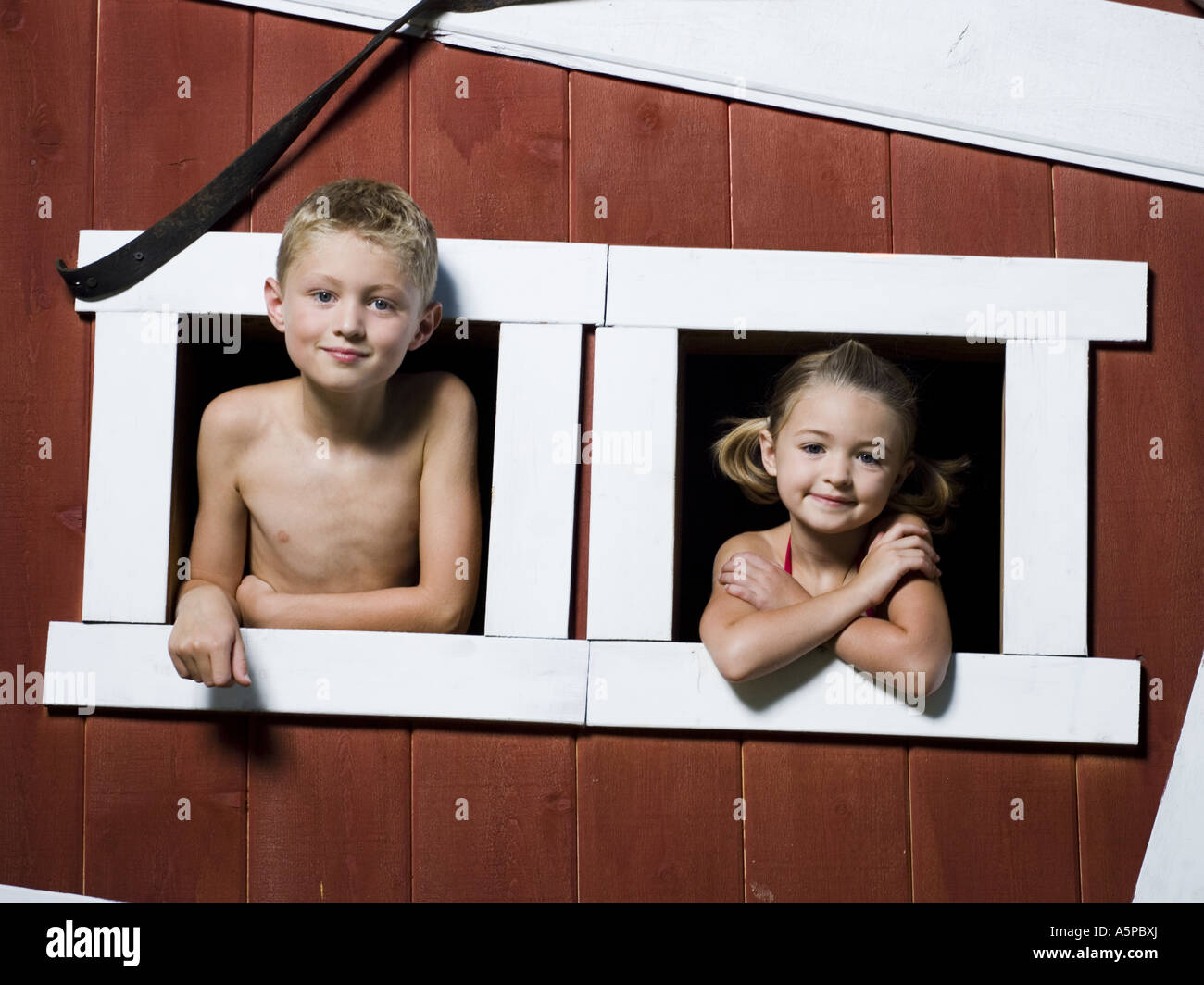 Boy and girl in a playhouse Stock Photo Alamy
