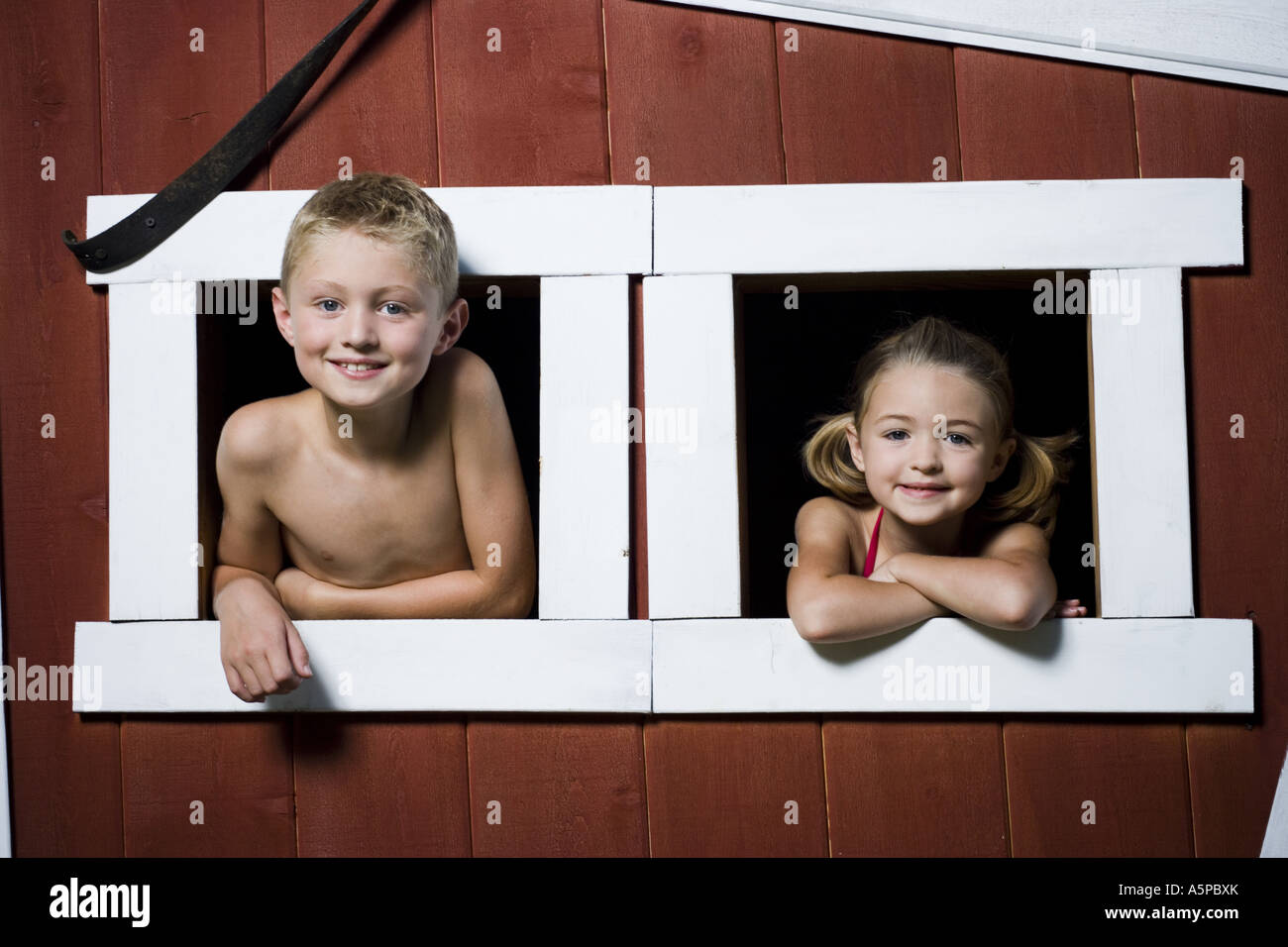 Boy and girl in a playhouse Stock Photo Alamy