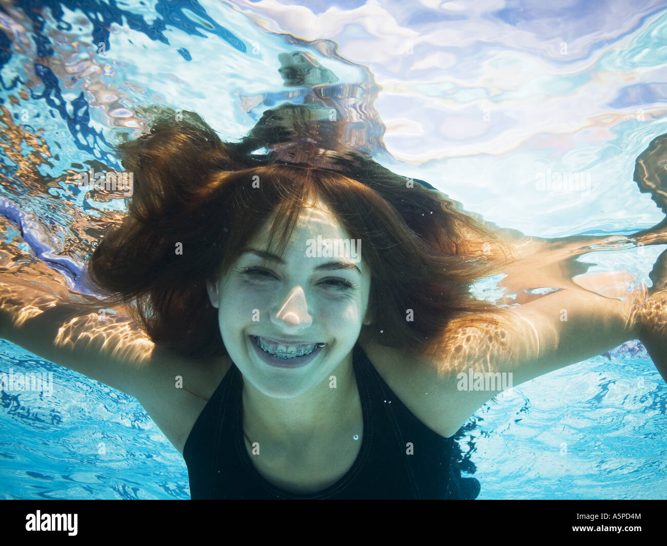 Girl swimming underwater in pool Stock Photo Alamy