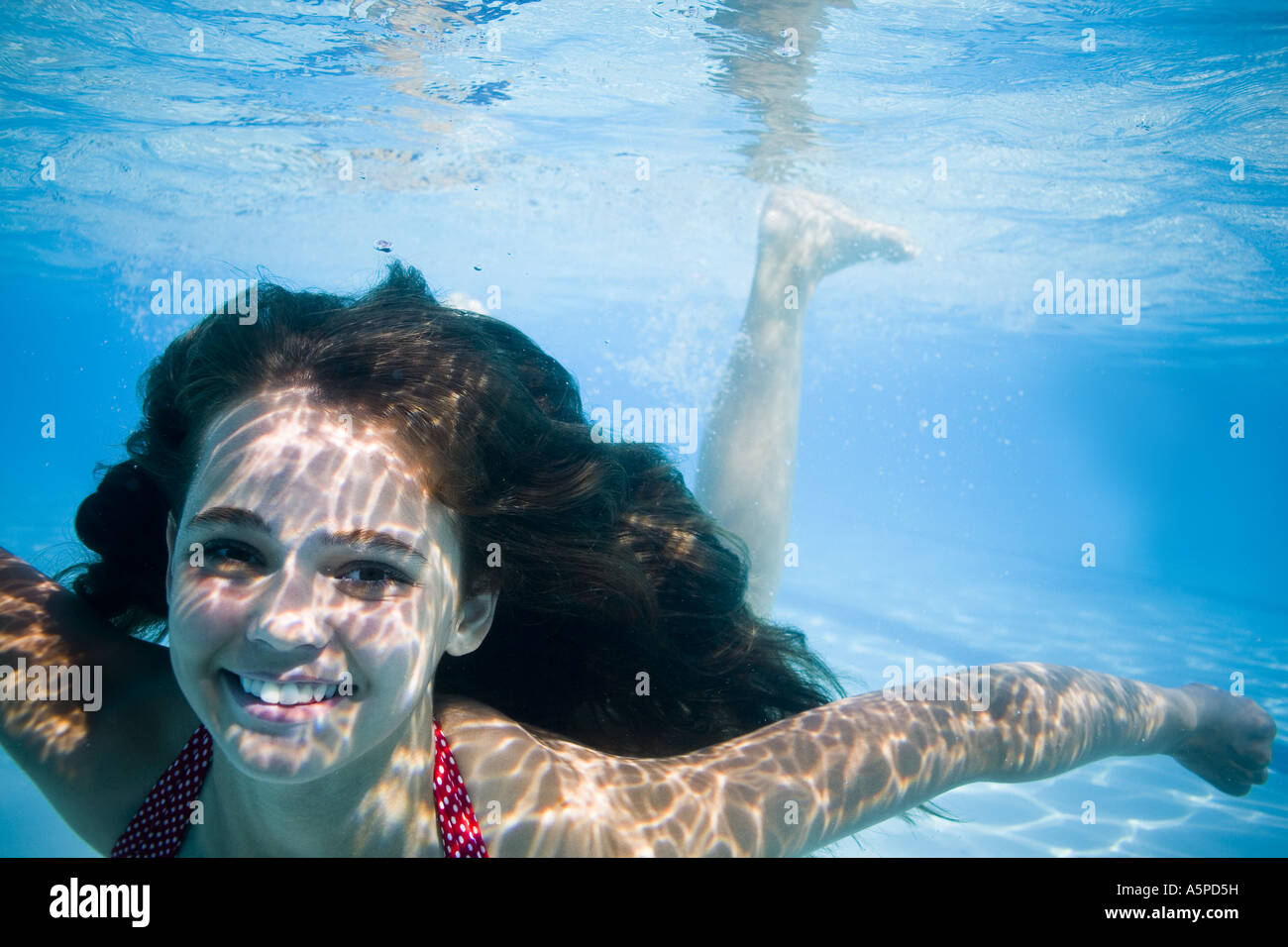 Girl swimming underwater in pool Stock Photo - Alamy