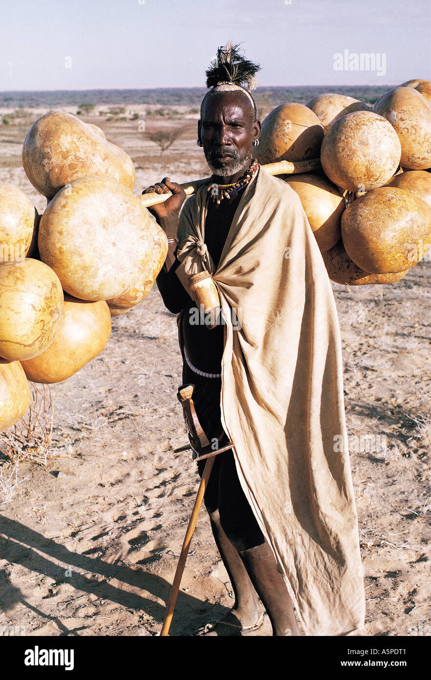 Turkana man carrying gourds to be used as water carriers Near Lodwar northern Kenya East Africa Stock Photo