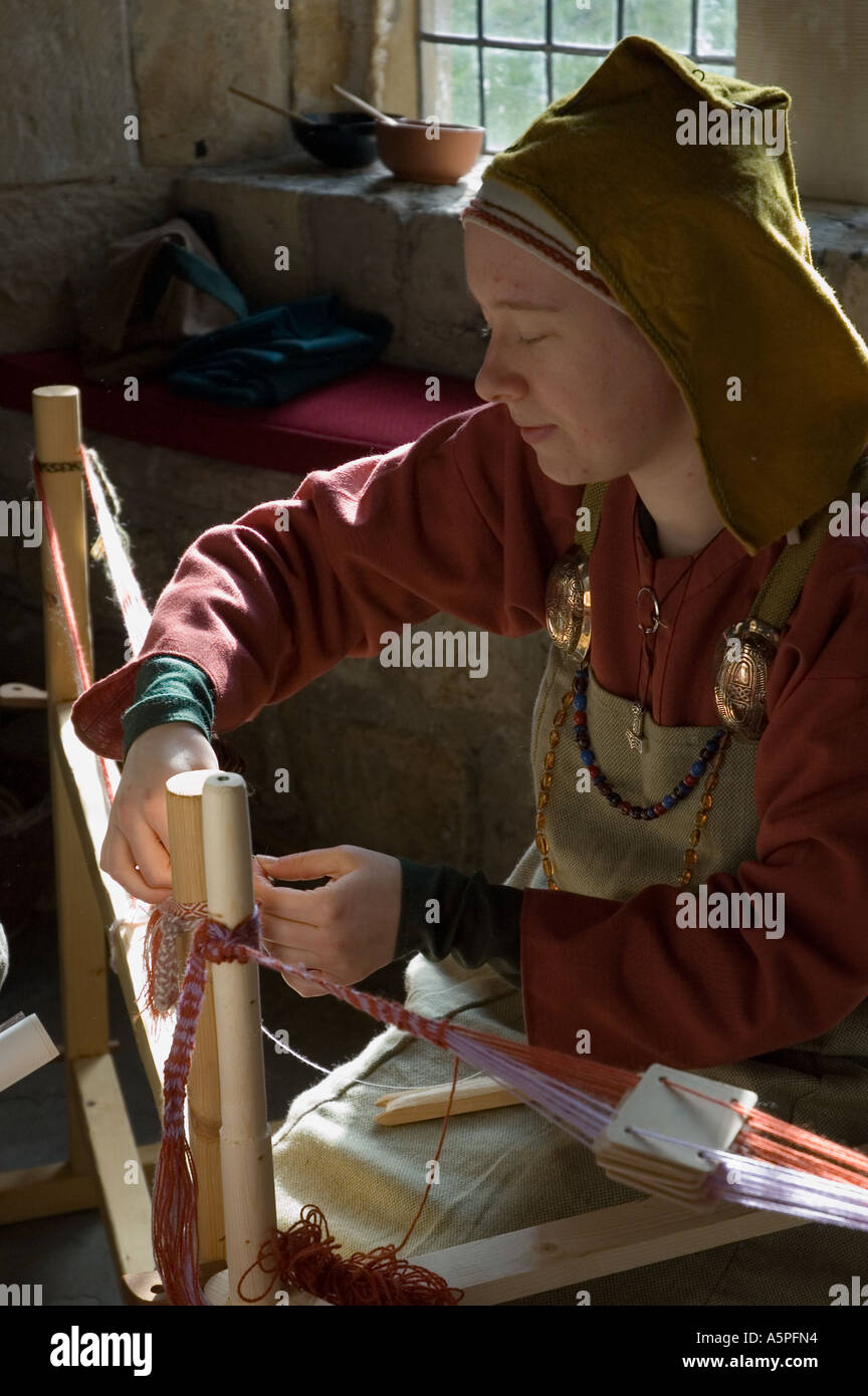 Woman dressed as a viking demonstrating viking weaving techniques Stock ...