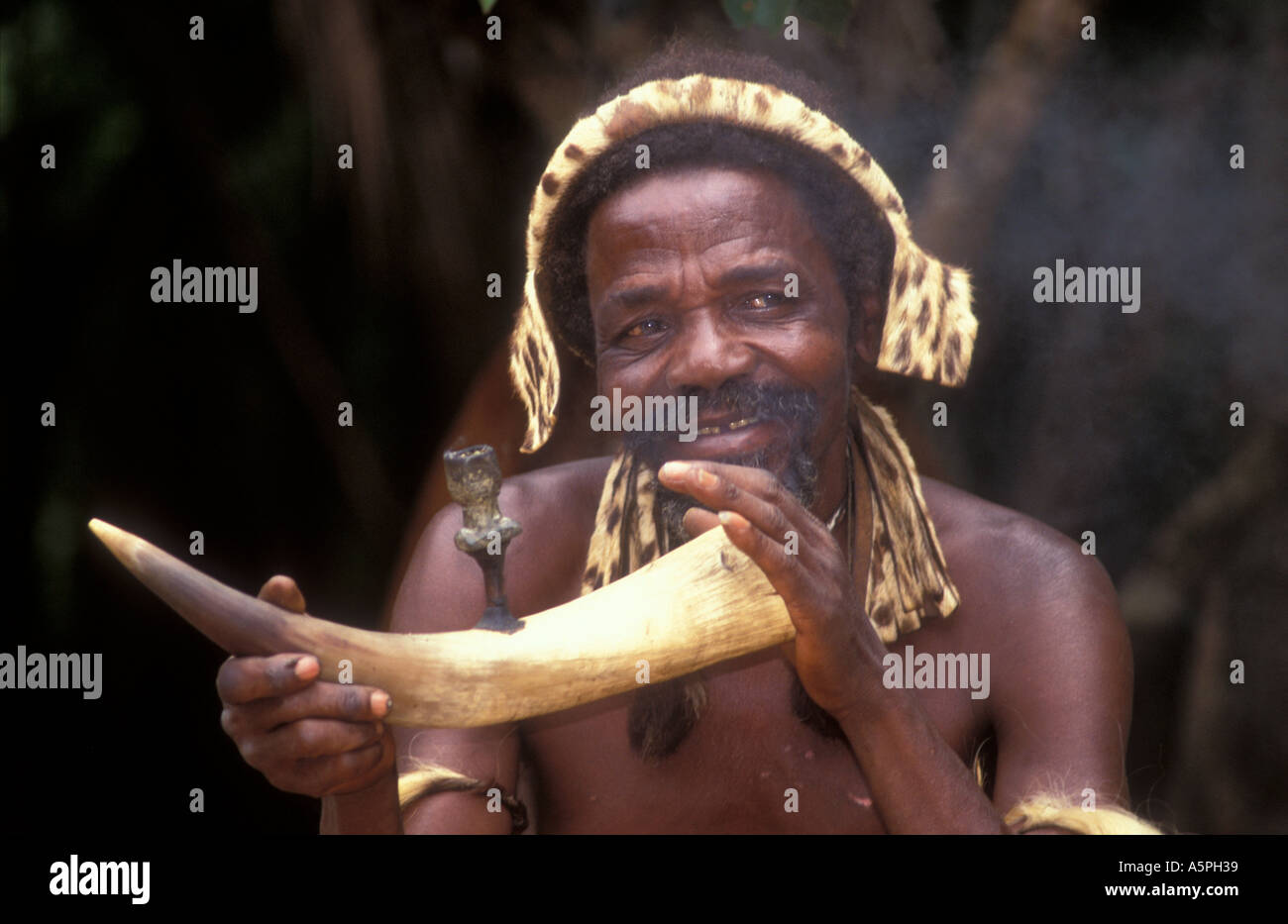Zulu man smoking a pipe Damazulu Kraal Kwa Zulu Natal South Africa Stock Photo