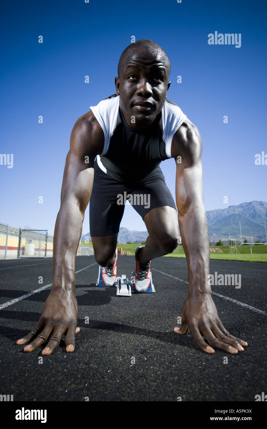 Track runner in starting position ready to race Stock Photo Alamy