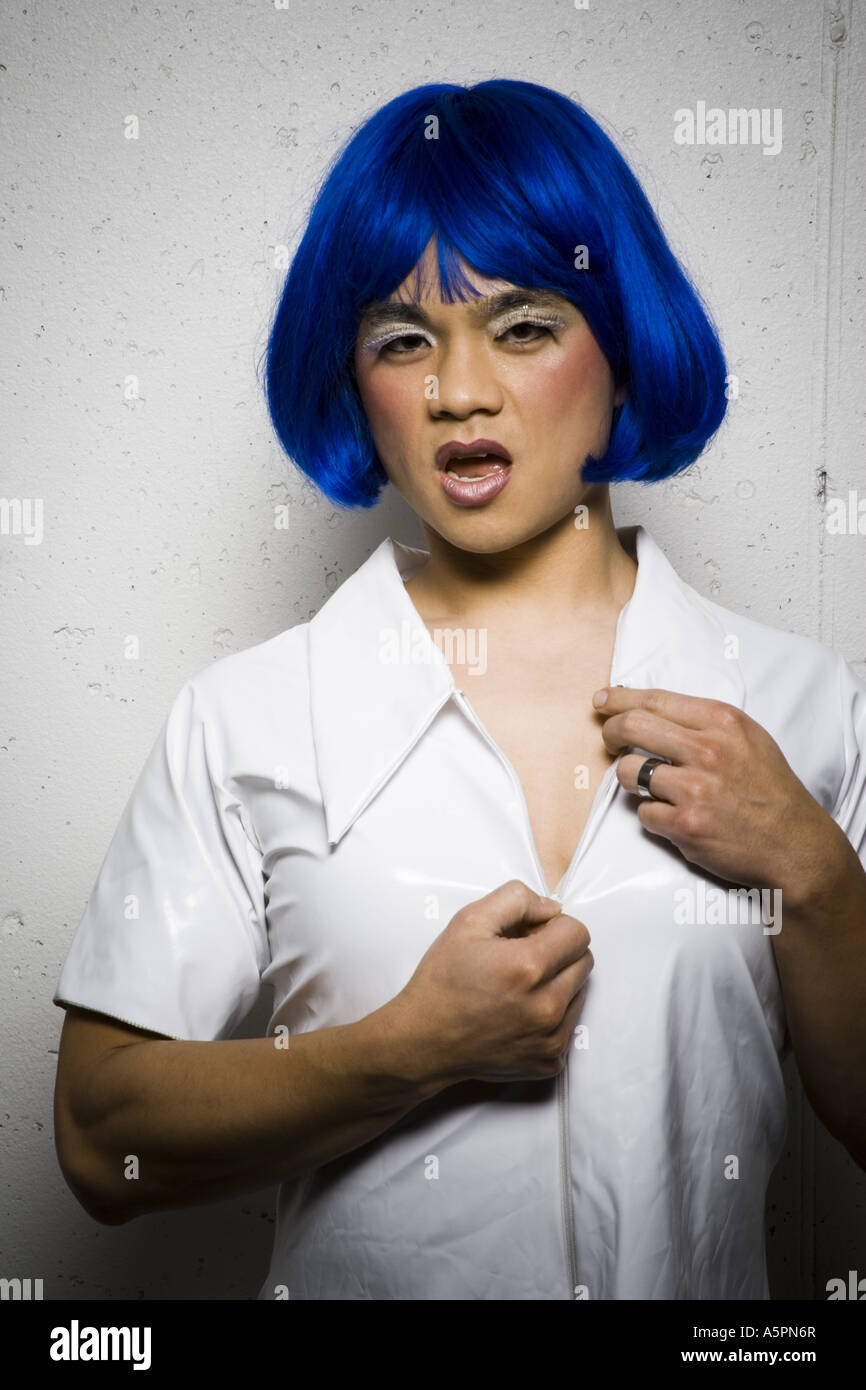 Man in blue wig and makeup flirting Stock Photo Alamy