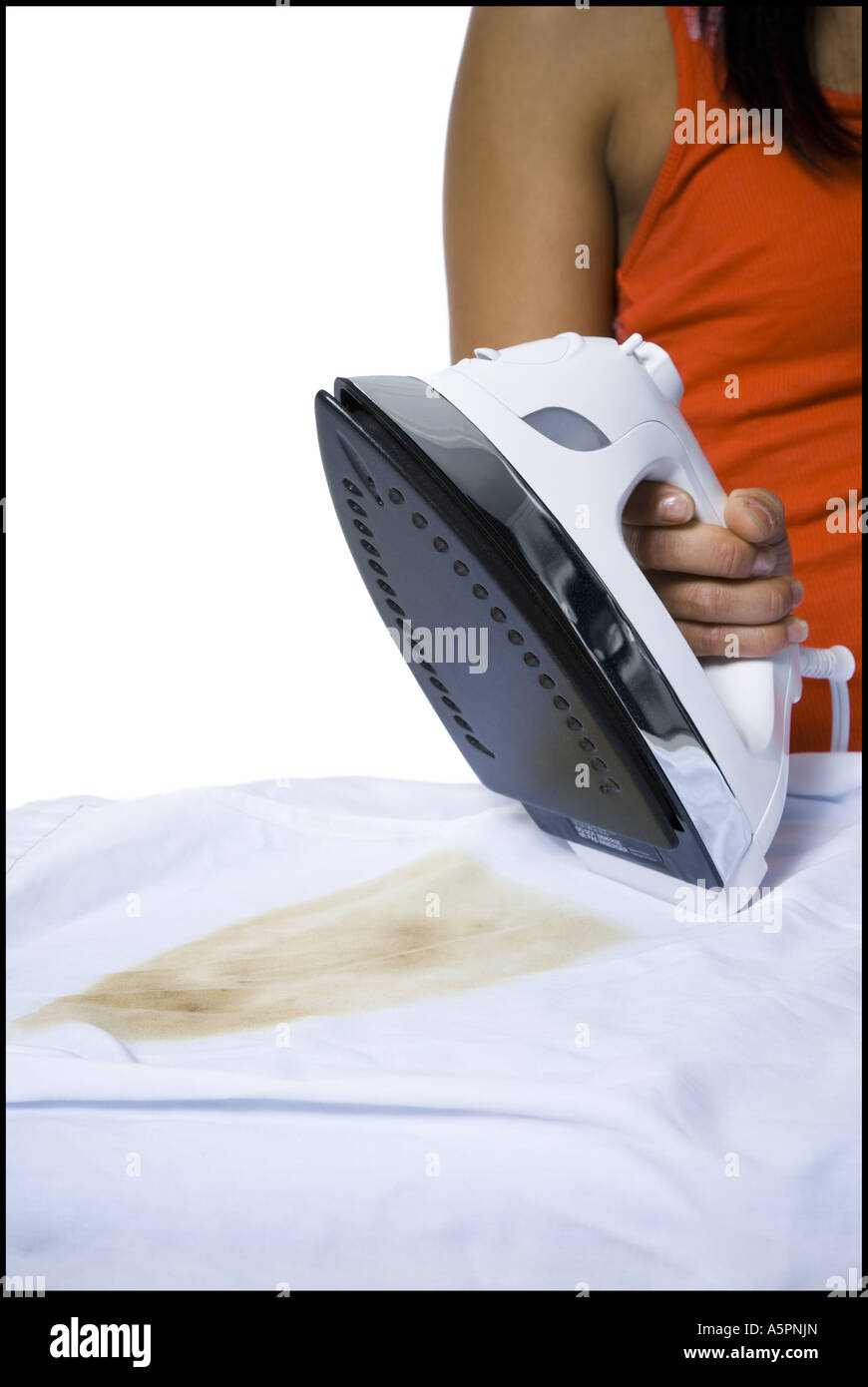 Distracted woman with iron and burned clothing Stock Photo