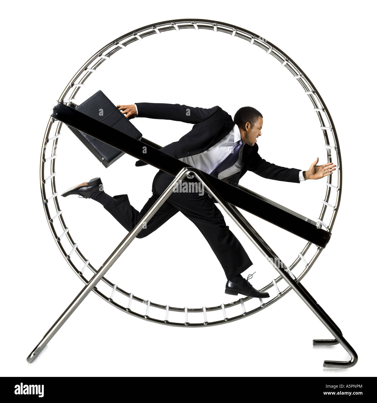 Businessman running in hamster wheel Stock Photo