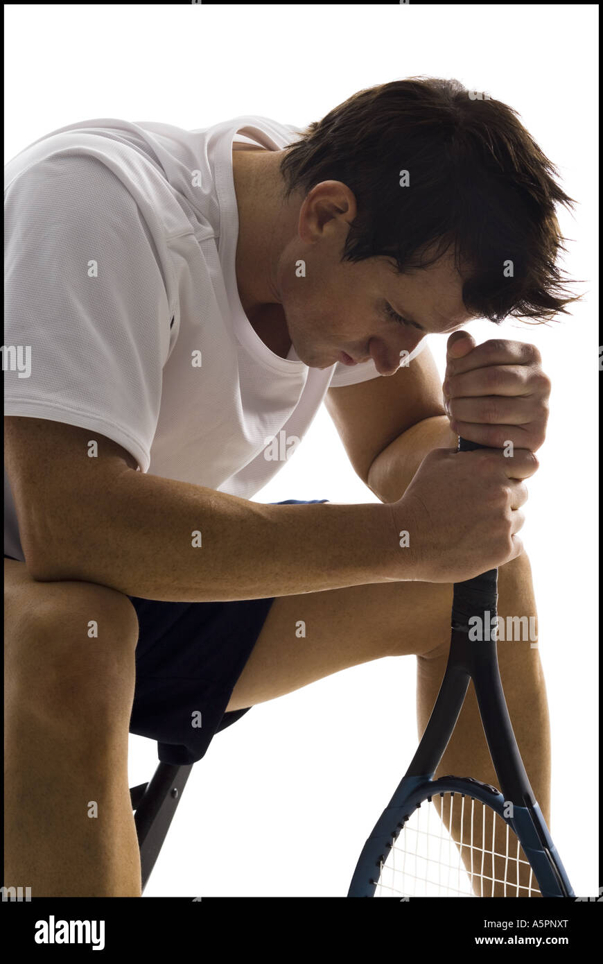 Male tennis player taking a break Stock Photo