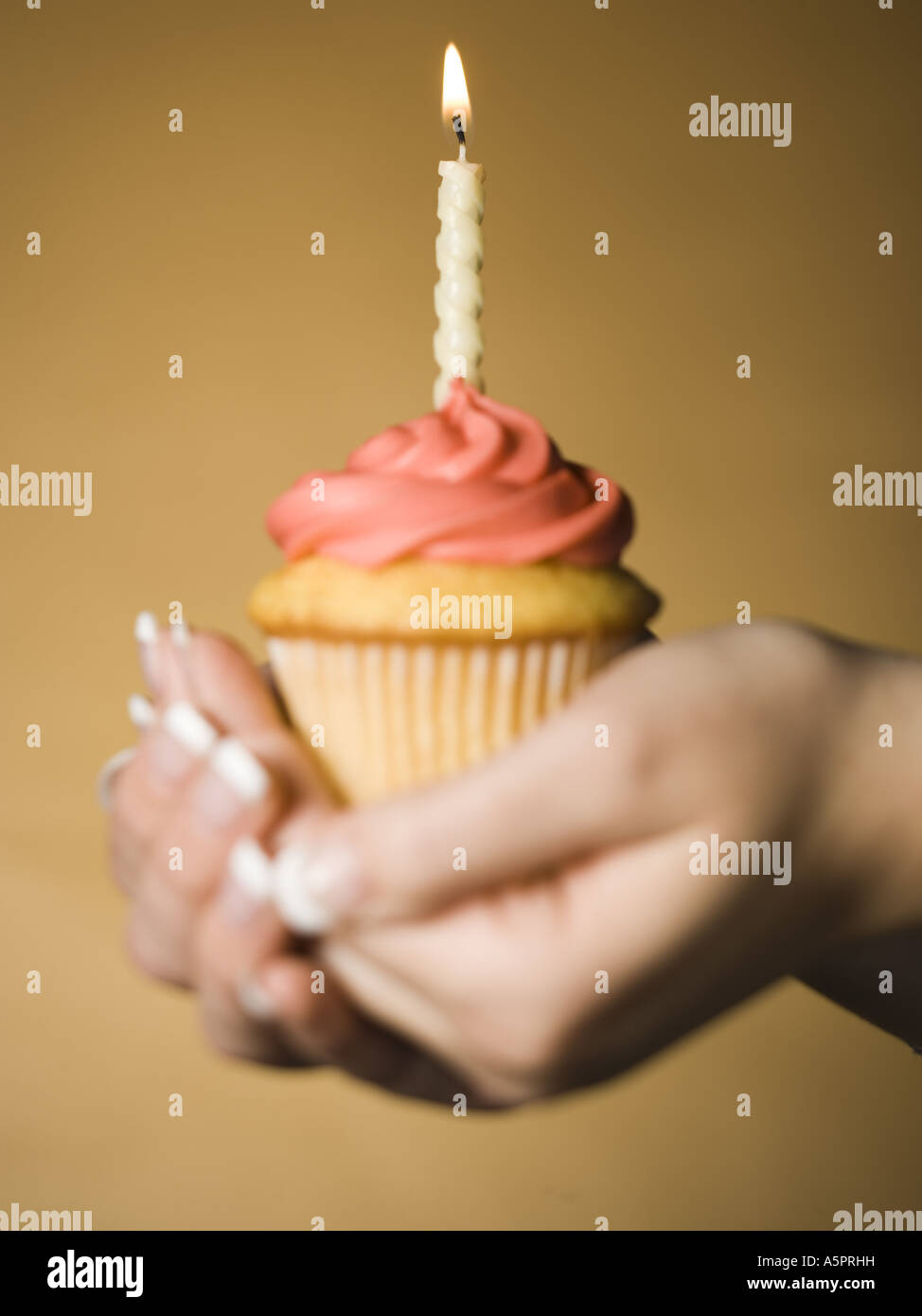 Hands Holding A Cupcake With One Birthday Candle Stock Photo Alamy