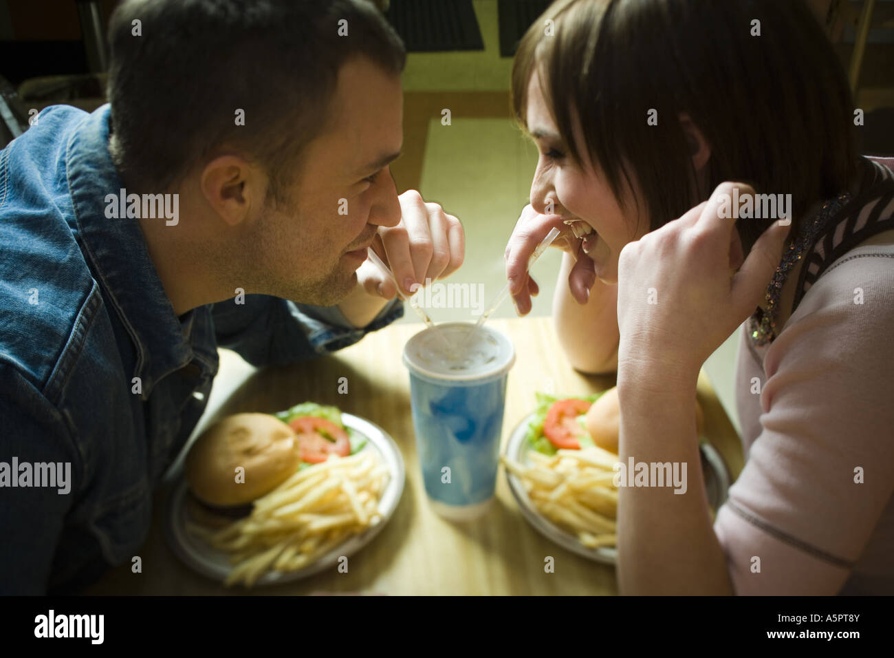 High angle view of a young man and a teenage girl looking at each other ...