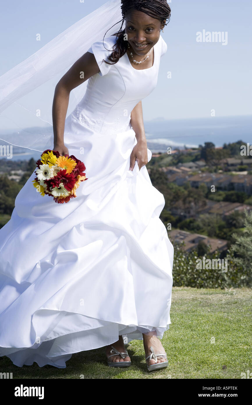 Portrait of a bride holding a bouquet of flowers and smiling Stock Photo