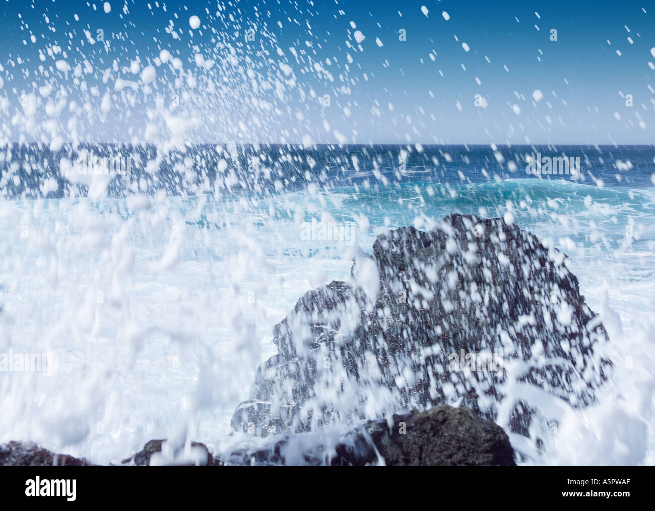 Black basalt volcanic beach and rough blue sea with white crested waves