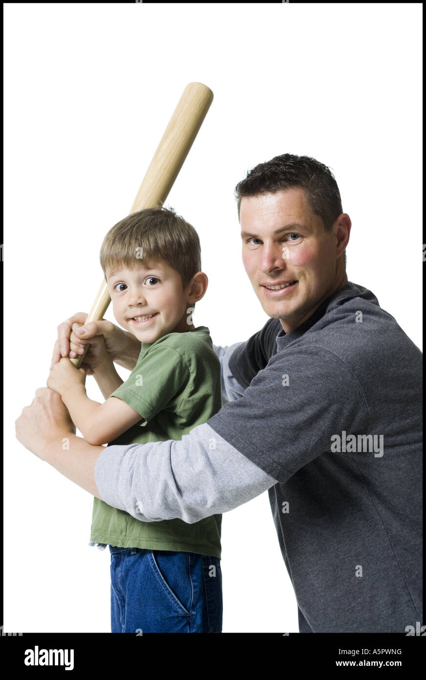 Portrait Of A Father Teaching His Son How To Swing A Baseball Bat Stock Photo Alamy