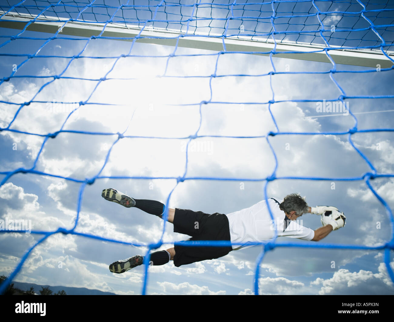 Soccer goalkeeper making diving save Stock Photo Alamy