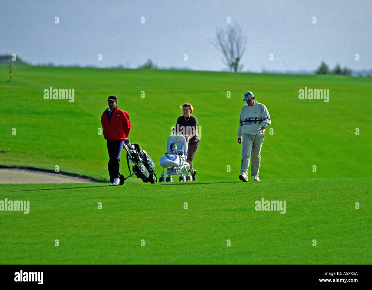 Progolfer Mike Tulloch with his wife and baby. Another hard day at the  office Stock Photo - Alamy
