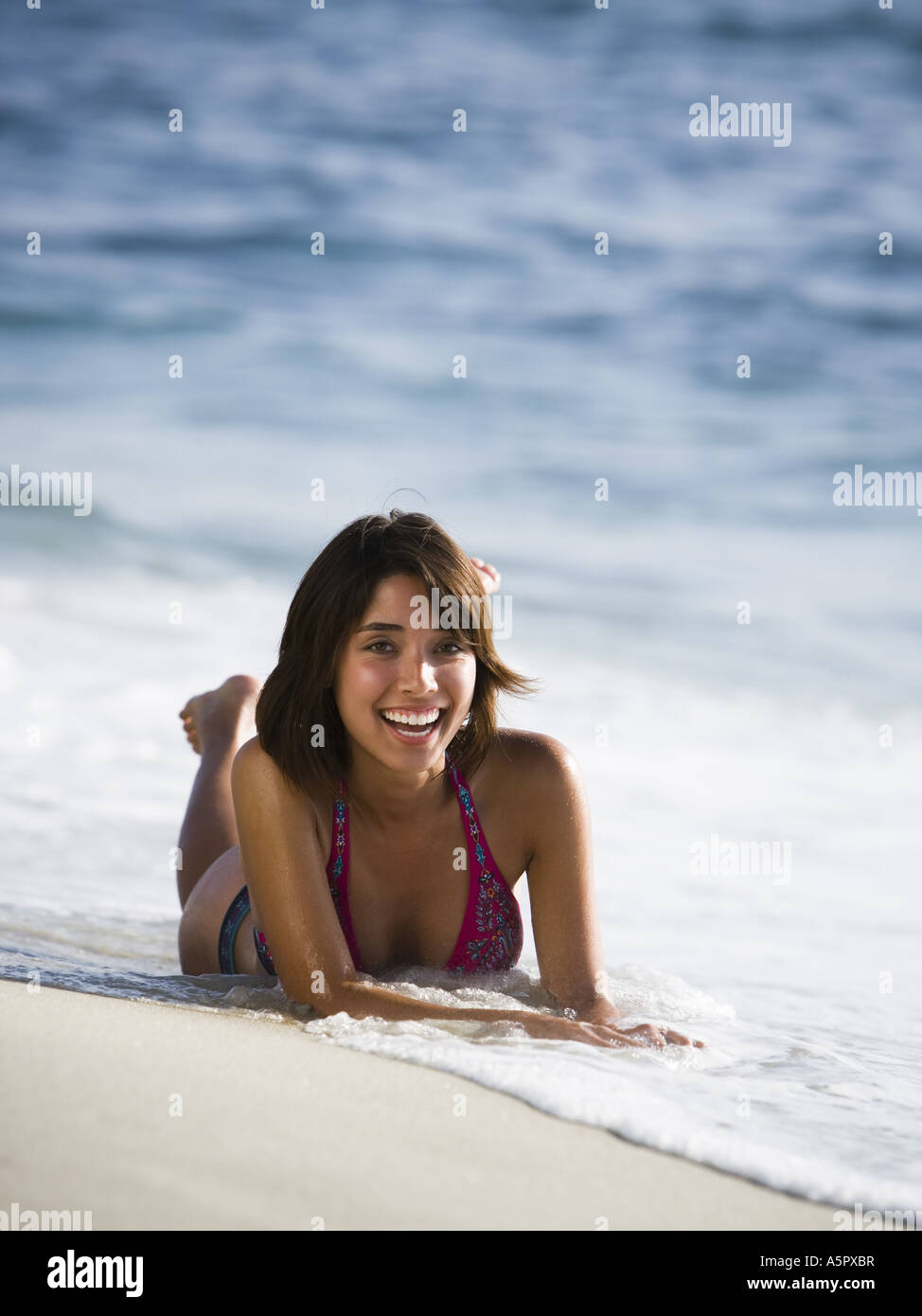 Woman sunbathing on beach Stock Photo Alamy